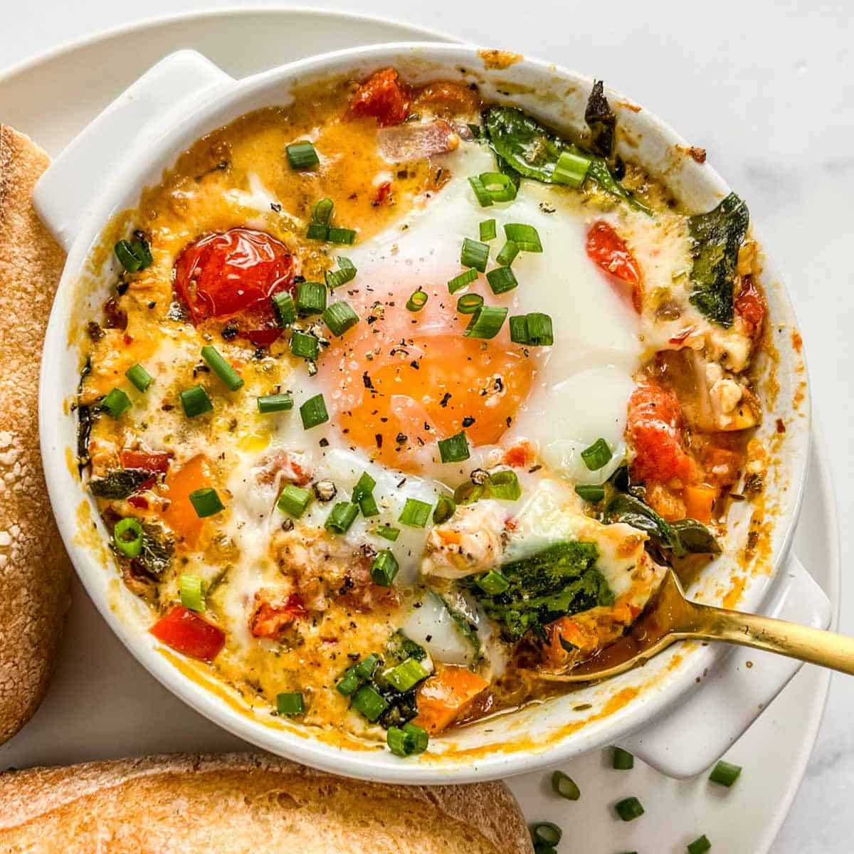 Baked Feta Eggs with Burst Tomatoes and Spinach